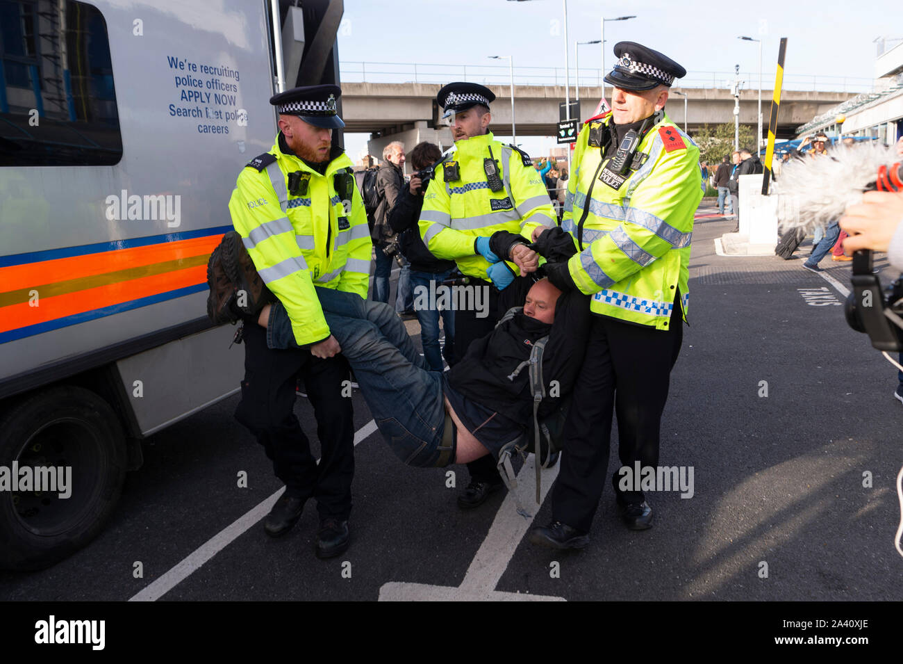 London, Britain. 10th Oct, 2019. An Extinction Rebellion protestor is arrested by police at City Airport in London, Britain, on Oct. 10, 2019. Credit: Ray Tang/Xinhua/Alamy Live News Stock Photo