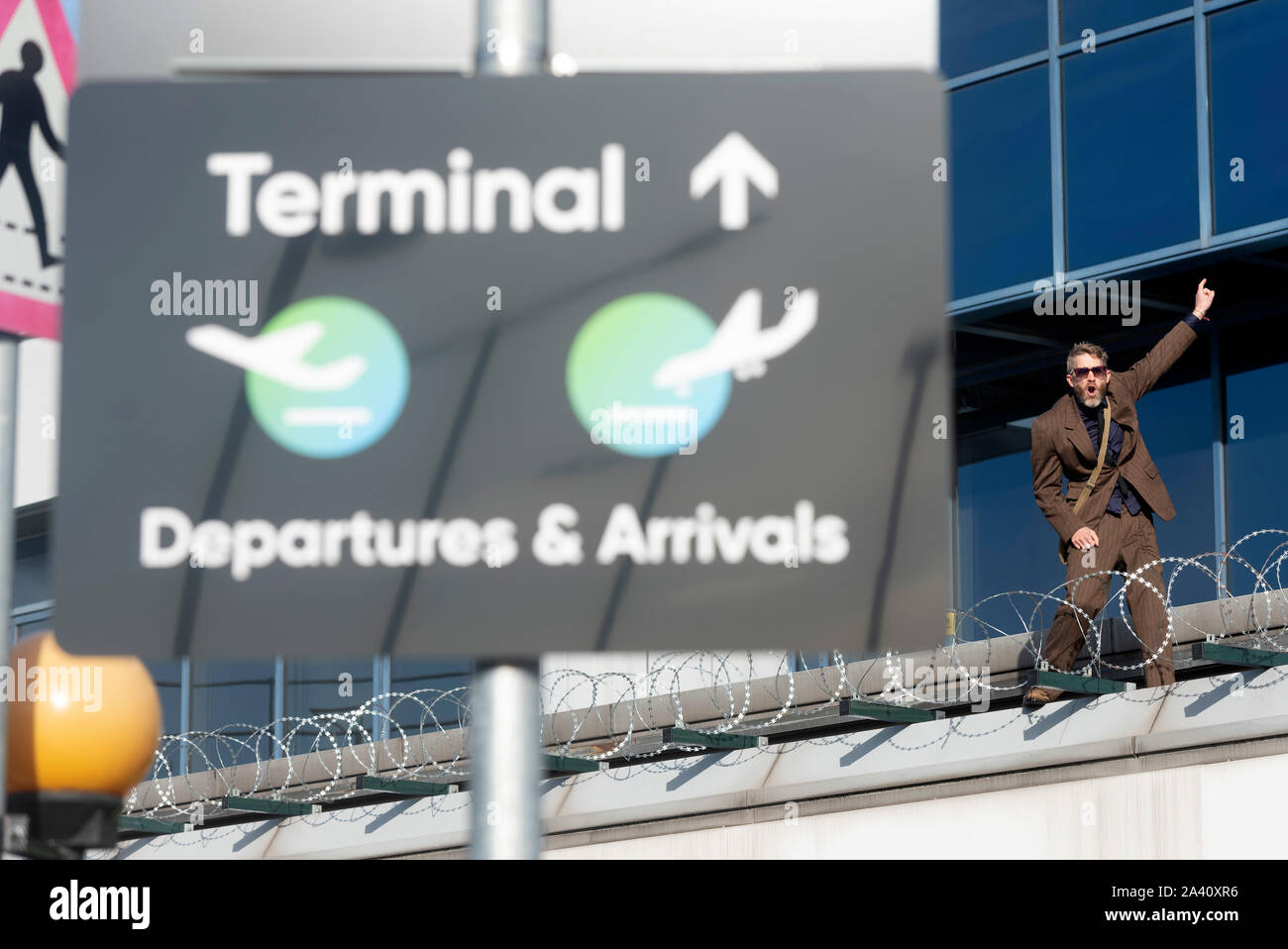 London, Britain. 10th Oct, 2019. An Extinction Rebellion protestor demonstrates at City Airport in London, Britain, on Oct. 10, 2019. Credit: Ray Tang/Xinhua/Alamy Live News Stock Photo