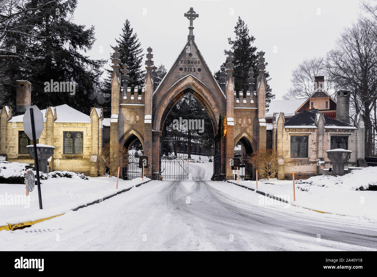 Old vintage cemetery gates architecture with snow and Christmas wreath