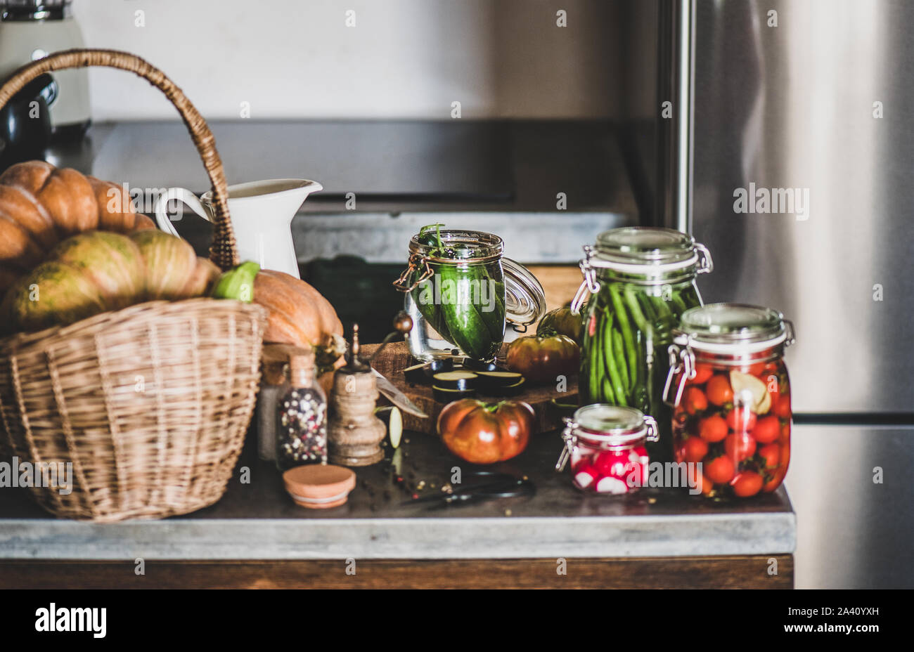 Fresh ingredients and glass jars with homemade vegetables preserves, close-up Stock Photo