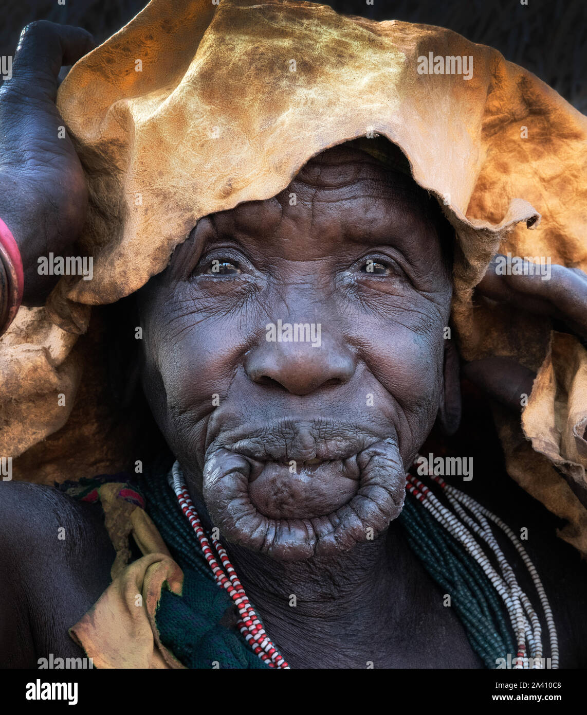 ETHIOPIA: A rare perspective of a elderly woman withour her lip plate. Photographer Dale Morris explained that women will stretch their lip over their Stock Photo
