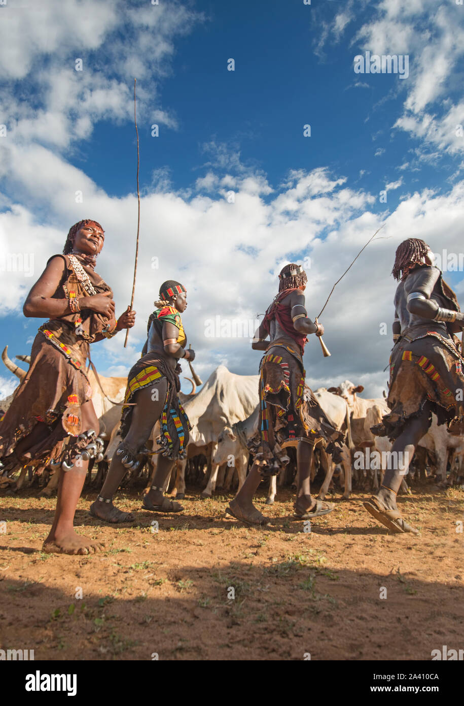 ETHIOPIA: Hamar women perform a dance to summon men to the area, hoping they're in line for a whipping. SHOCKING pictures show the strange customs of Stock Photo