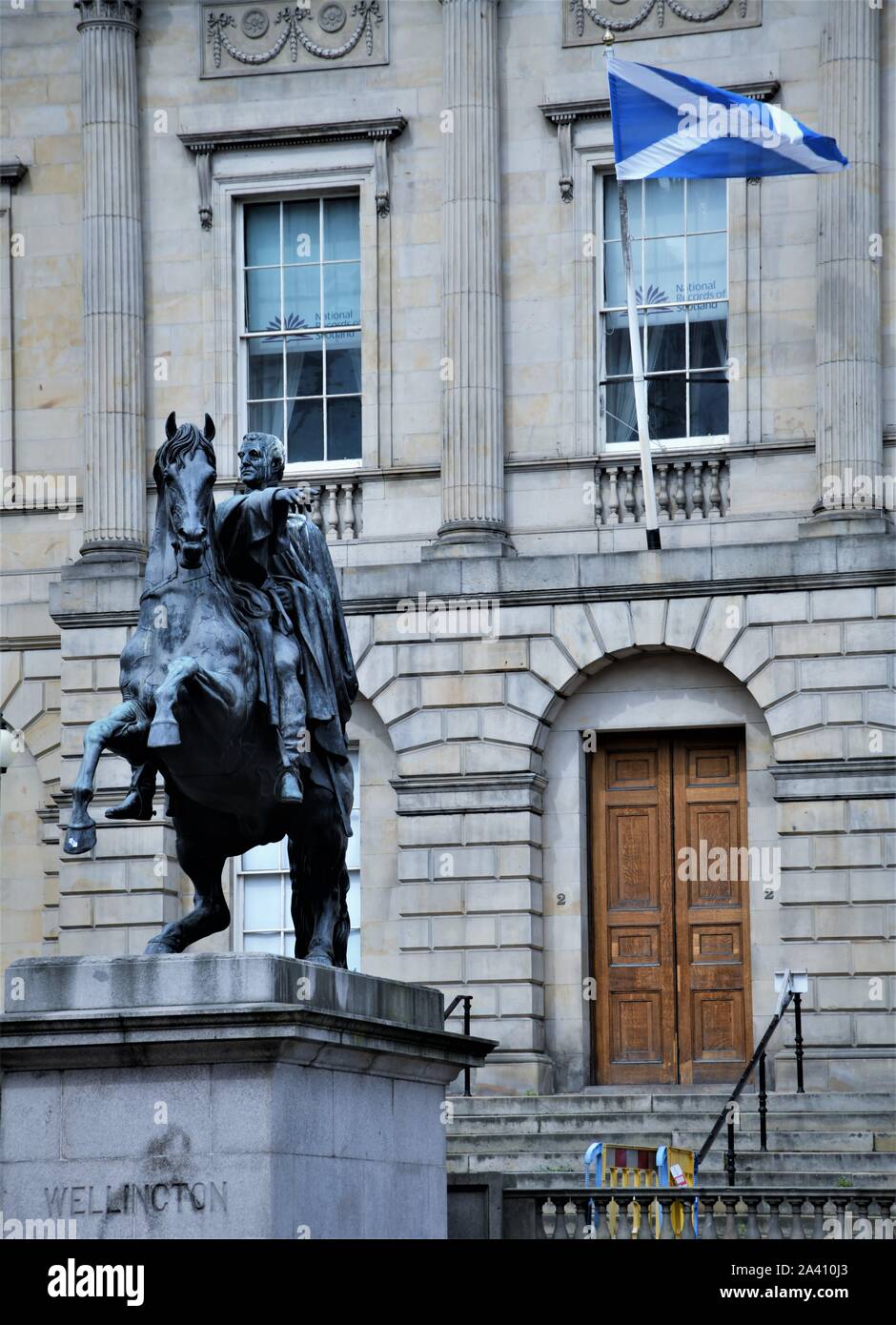 The Iron Duke - Duke of wellington Statue on Princess Street outside the Scottish Register Office under the Saltire on Princess Street Edinburgh.. Stock Photo