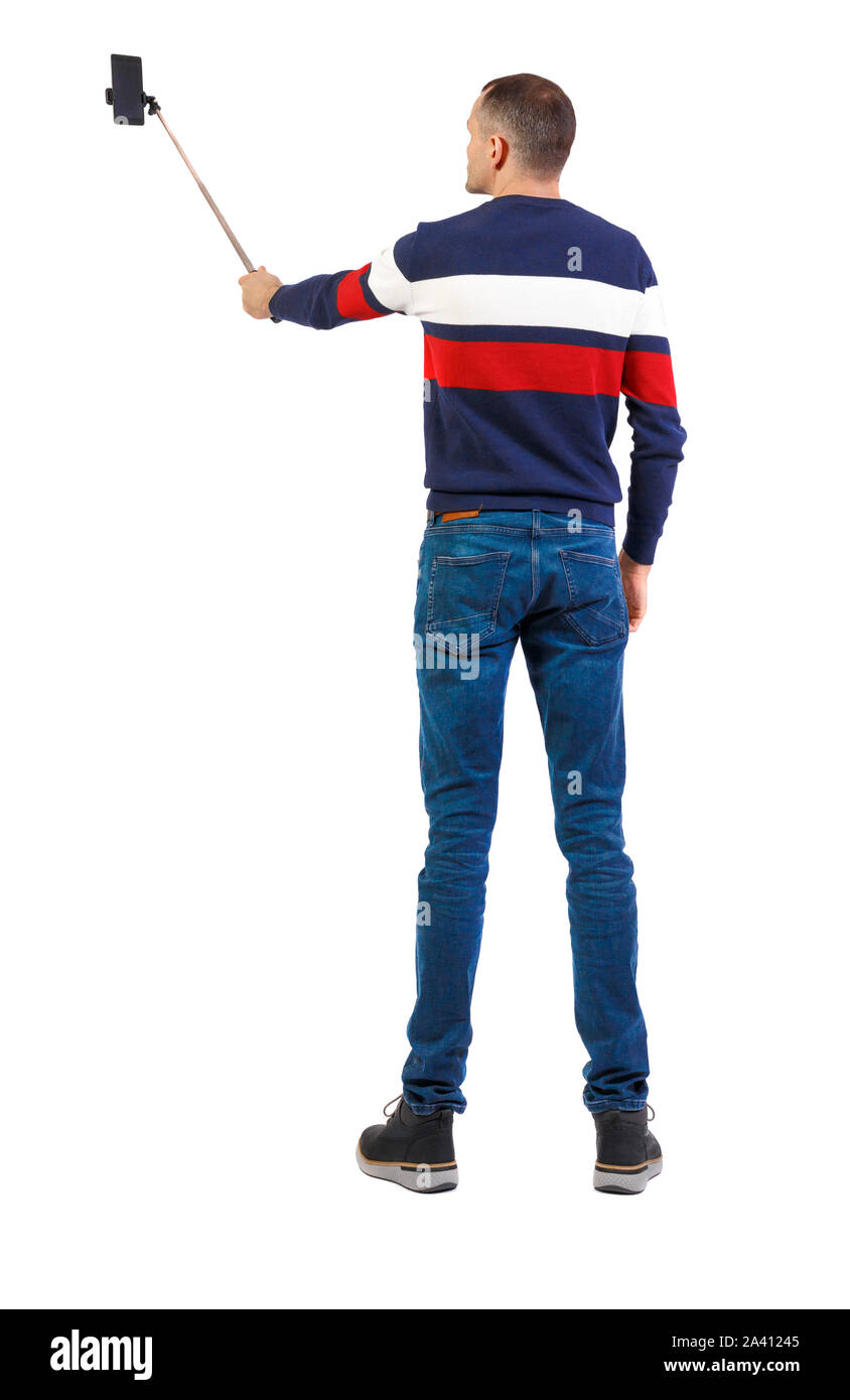 Man Using Mobile Back View back view of standing young guy with smartphone in the hands of. Rear ...