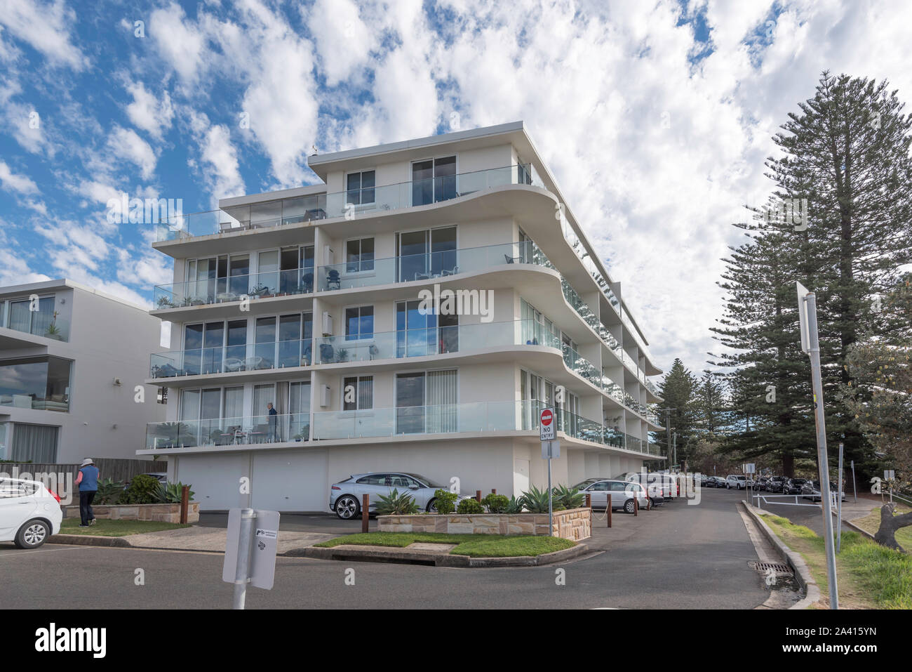 A modern four level apartment block beside overlooking the ocean at