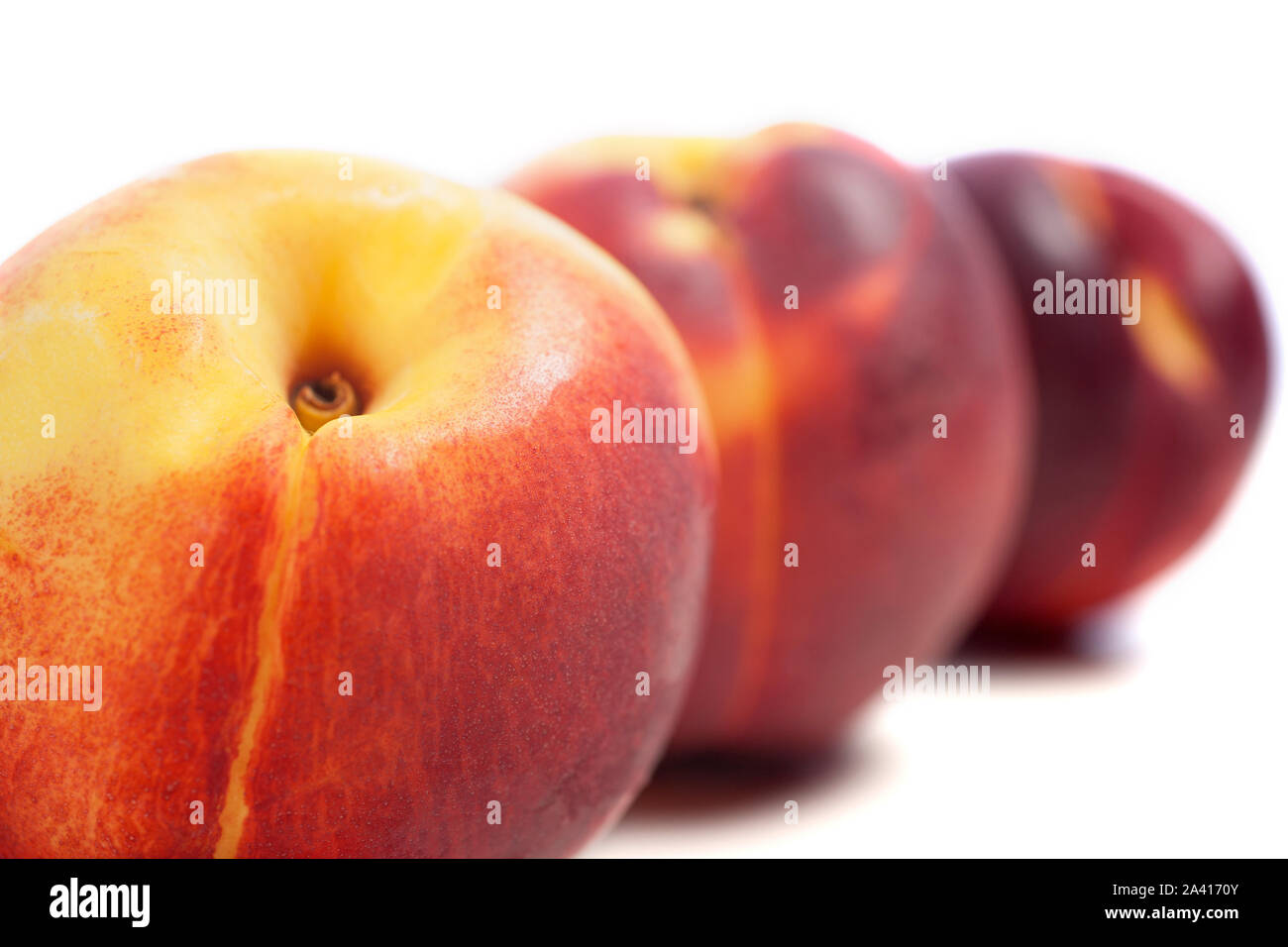 Three fresh nectarines on an isolated background Stock Photo