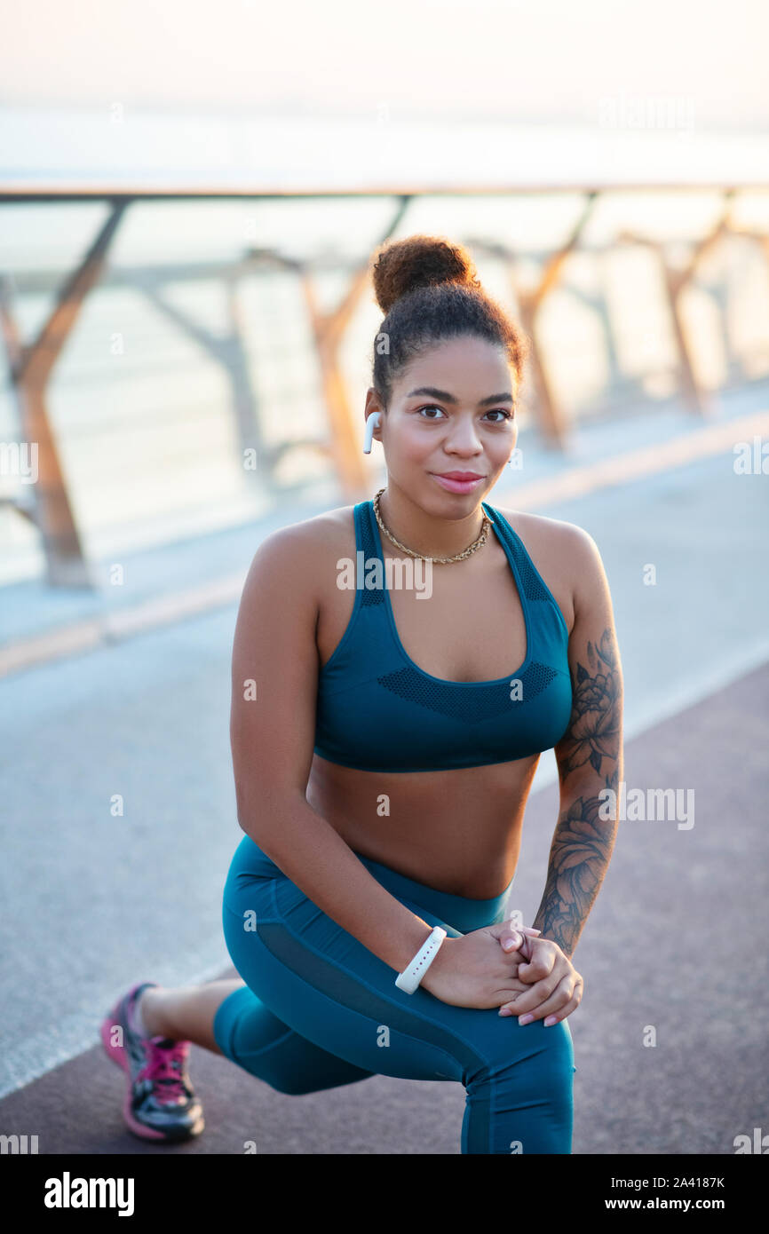 Dark-eyed woman feeling good while working out outside Stock Photo