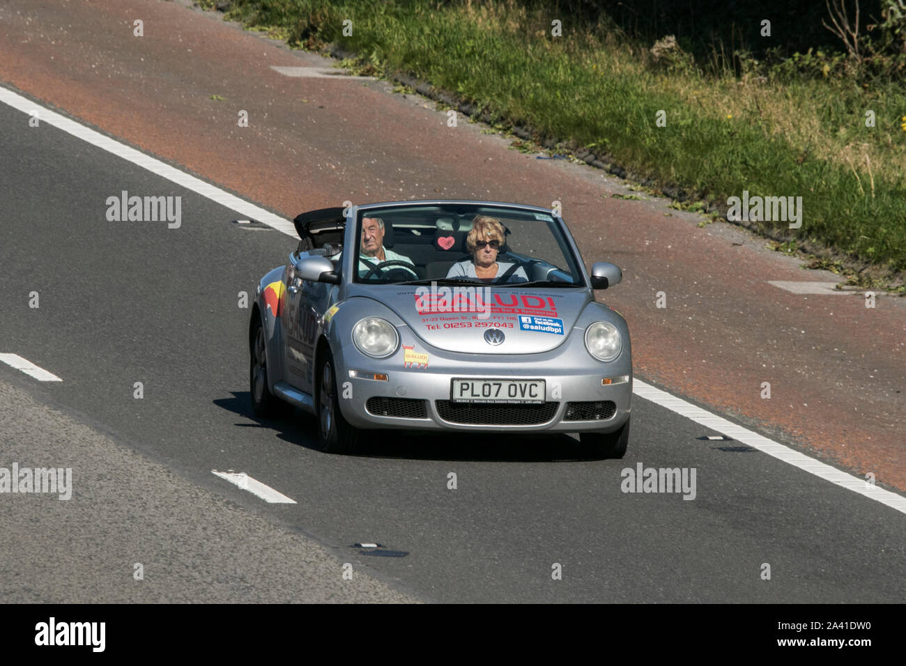 isalud Volkswagen Beetle Luna 102Ps silver convertible traveling on the M61 motorway near Manchester, UK Stock Photo