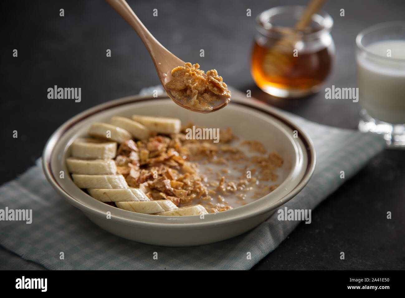 Plate with integral oatmeal flake with banana fruits, human hand with ...