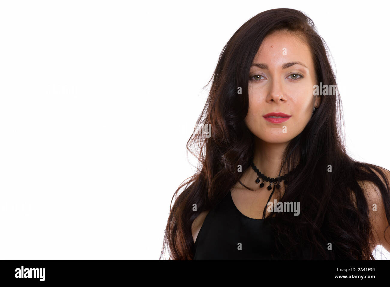 Studio portrait of beautiful young woman isolated against white