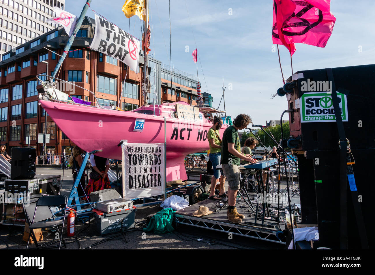 Extinction rebellion summer uprising protests in Bristol on July 18th 2019 - protesters occupying Bristol Bridge, Bristol, UK, with boat and band Stock Photo