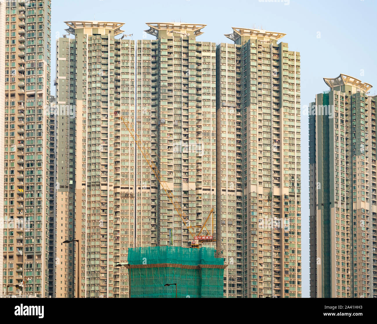 Facade of dense urban high-rise apartment buildings in LOHAS Park new housing estate in New Territories of Hong Kong, China. Stock Photo