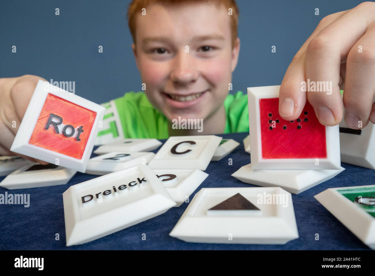 11 October 2019, Bavaria, Nuremberg: Noel Mang, pupil and inventor, presents his 3D memory during the innovation show at the International Inventors' Fair 'iENA'. The three-dimensionally designed tokens are suitable for educational purposes as well as, among other things, for blind and elderly people. The fair takes place from 31 October to 3 November in Nuremberg. Photo: Daniel Karmann/dpa Stock Photo