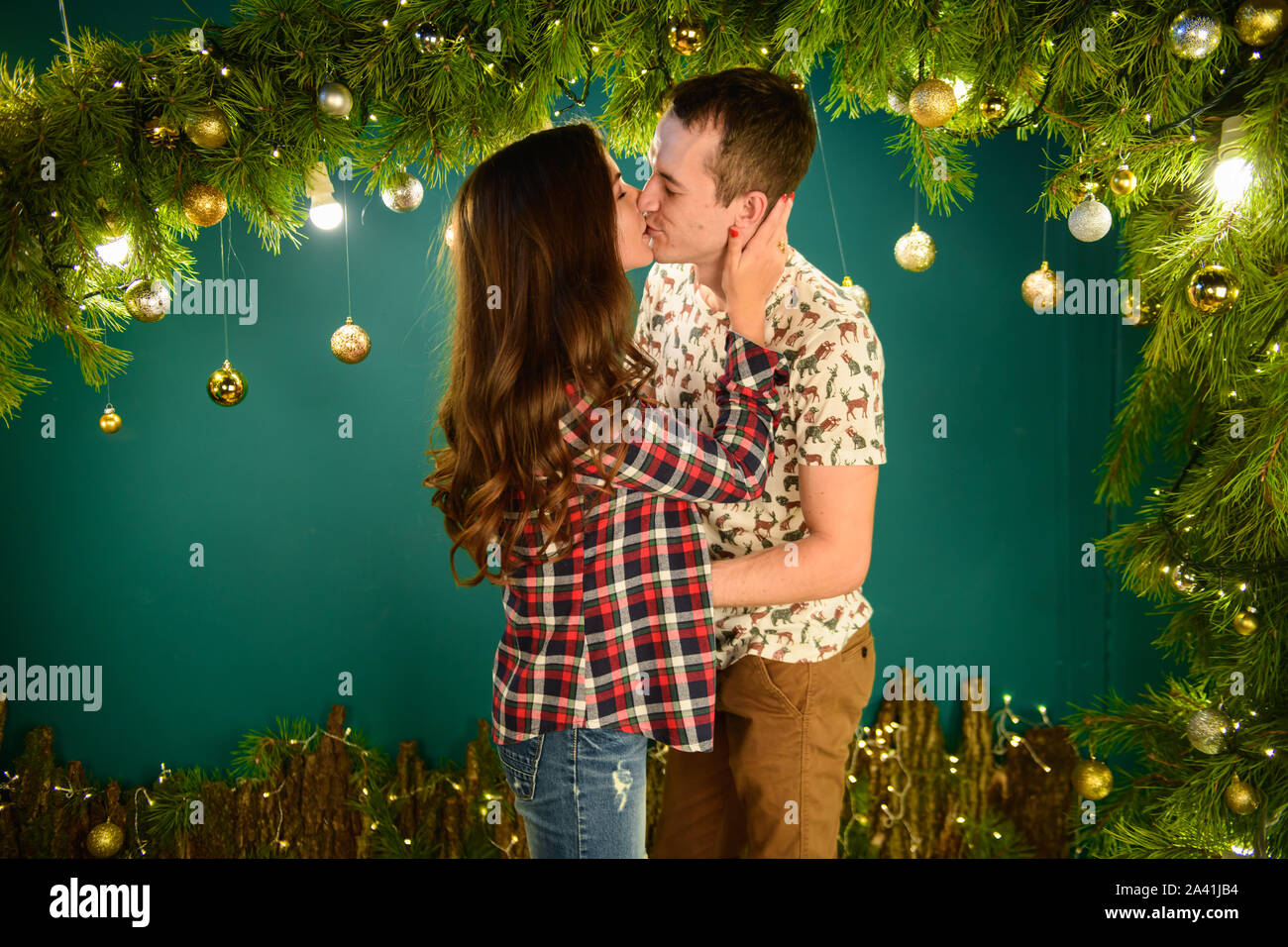 couple in love near christmas background. Young couple kissing near  Christmas tree. Low key. Silhouette Stock Photo - Alamy