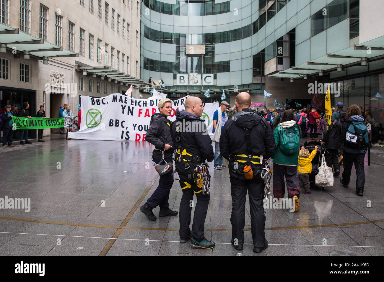 London, UK. 11 October, 2019. Specialist police officers prepare to remove climate activists from Extinction Rebellion standing on the glass parapet above the main entrance to the BBC’s New Broadcasting House on the fifth day of International Rebellion protests. The activists were demanding that the broadcaster ‘tell the truth’ regarding the climate emergency. Credit: Mark Kerrison/Alamy Live News Stock Photo