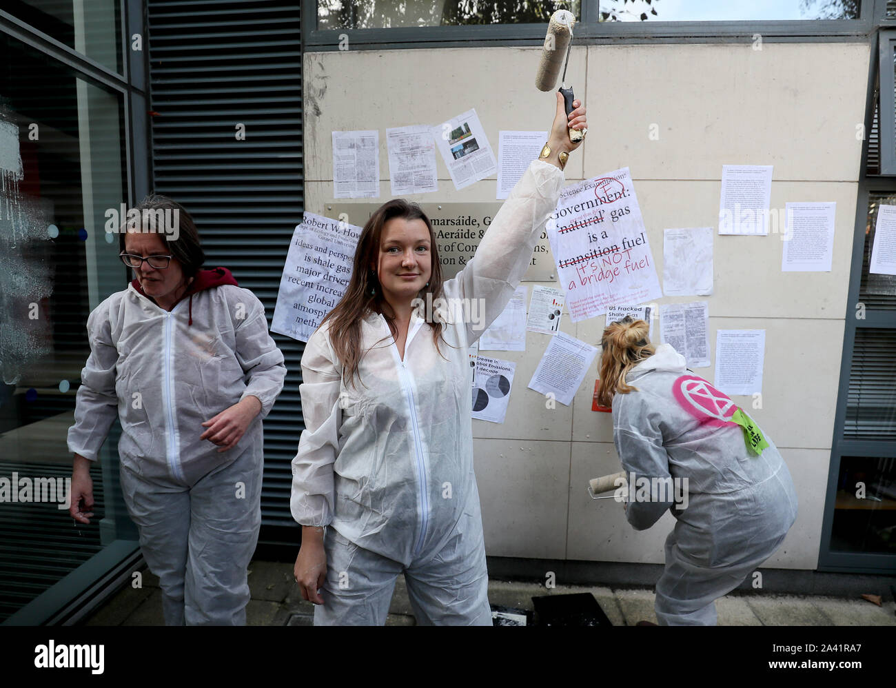 Extinction Rebellion (XR) protestors wallpaper the front of the Department of Communications, Climate Action and Environment, Dublin, with pages of science detailing the climate impact of fracked gas. Stock Photo