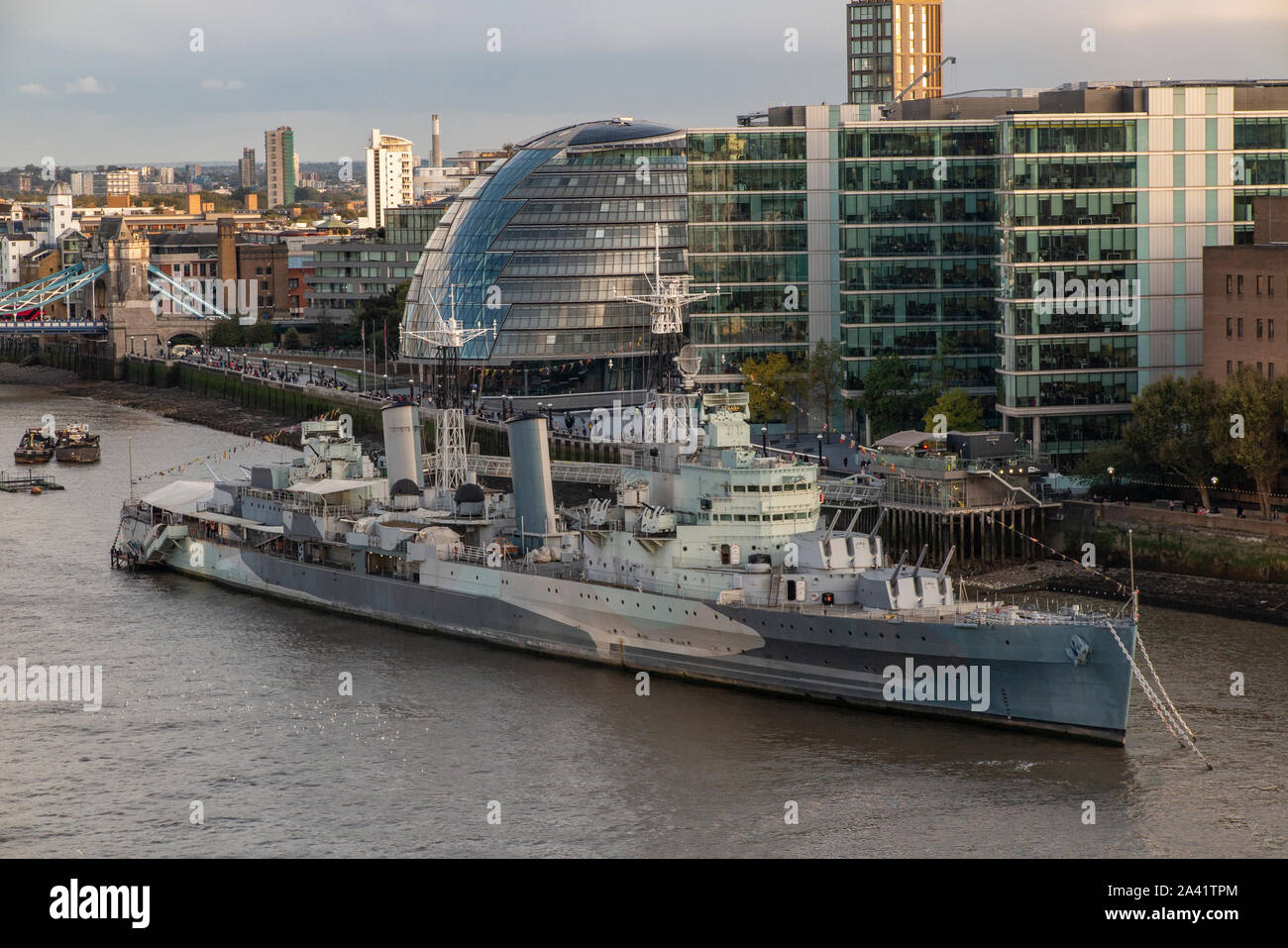 HMS Belfast on the River Thames, with the Mayor's Office (City Hall) in teh background Stock Photo