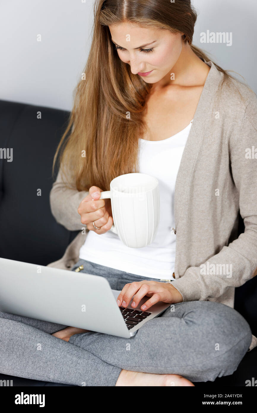 Beautiful young woman working from home on her laptop Stock Photo - Alamy