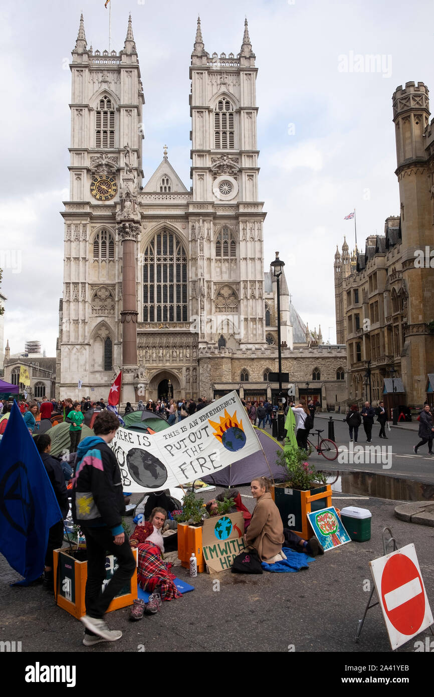 Young protesters on the edge of an Extinction Rebellion encampment outside Westminster Cathedral, London Stock Photo