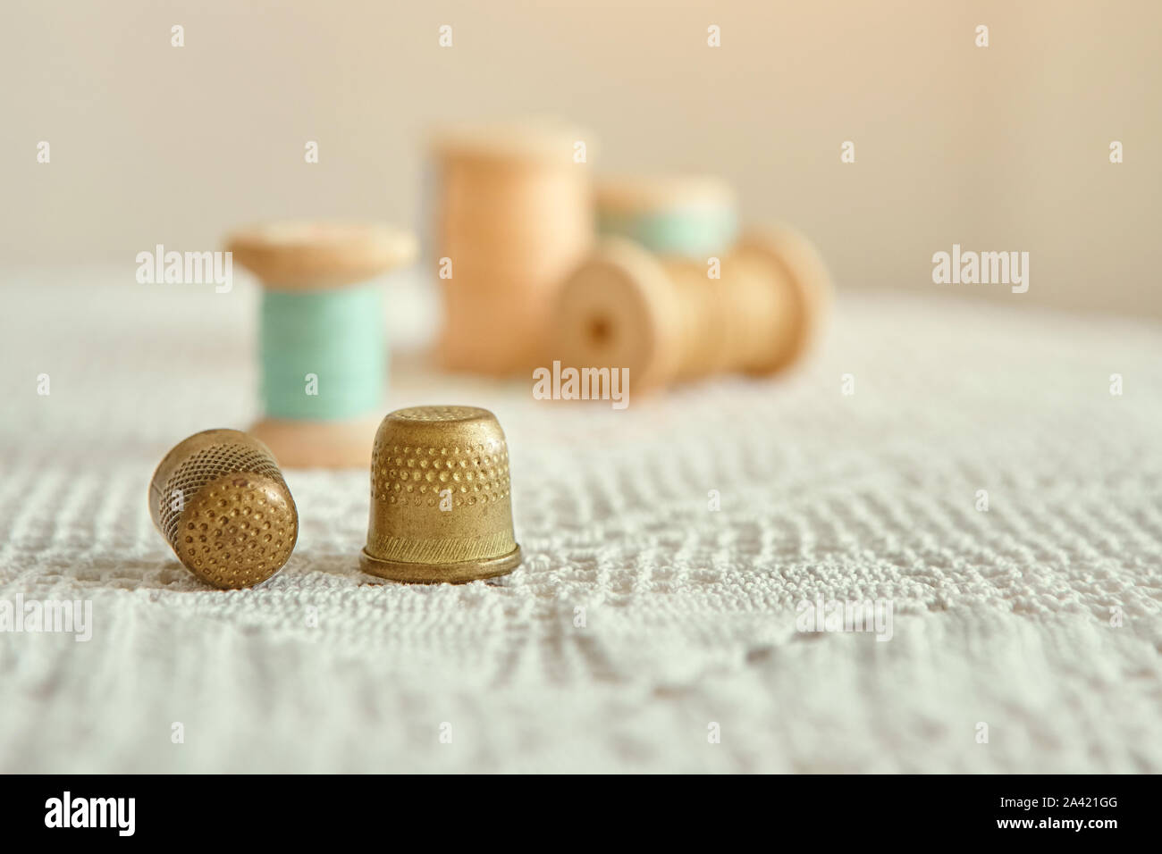The Girl Holds A Needle And Two Thimbles In Her Hands Vintage Thimble Sewing  Against The Background Of Pink And White Fabric Stock Photo - Download  Image Now - iStock
