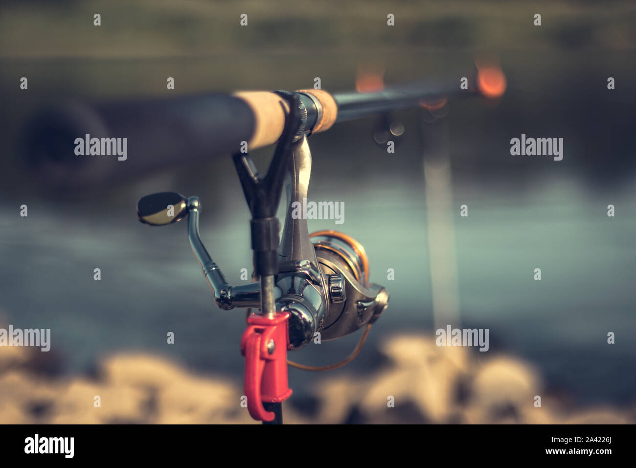 Fishing rod with a blurred background on a beautiful sunny day Stock Photo