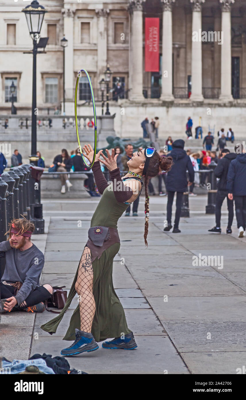 October 8th, 2019. The first day of Extinction Rebellion's occupation of Trafalgar Square. This demonstrator has brought her hula hoop. Stock Photo