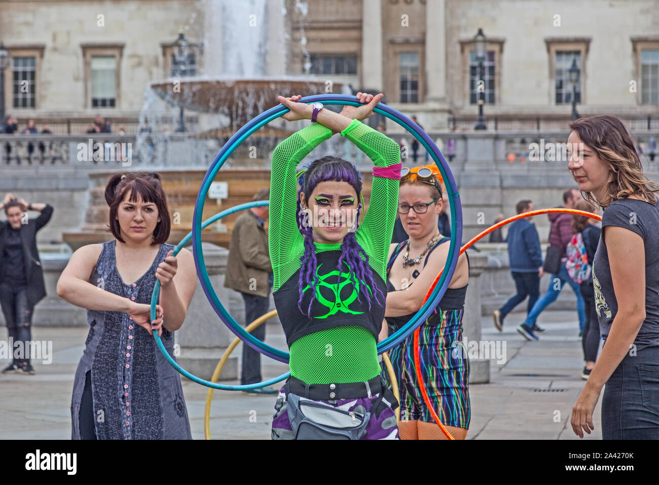 October 8th, 2019. The first day of Extinction Rebellion's occupation of Trafalgar Square.  Demonstrators whiling away the time with hula hoops. Stock Photo