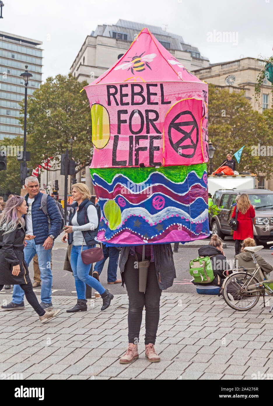October 8th, 2019. The first day of Extinction Rebellion's occupation of Trafalgar Square.  A colourful modern equivalent of the sandwich board. Stock Photo