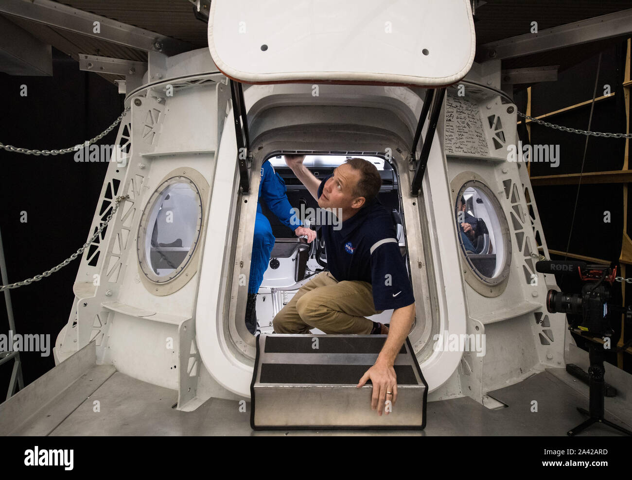 Hawthorne, United States. 11th Oct, 2019. NASA Administrator Jim Bridenstine climbs out of a mockup of the Demo-2 Crew Dragon during a tour of the SpaceX Headquarters on October 10, 2019, in Hawthorne, CA. NASA Photo by Aubrey Gemignani/UPI Credit: UPI/Alamy Live News Stock Photo