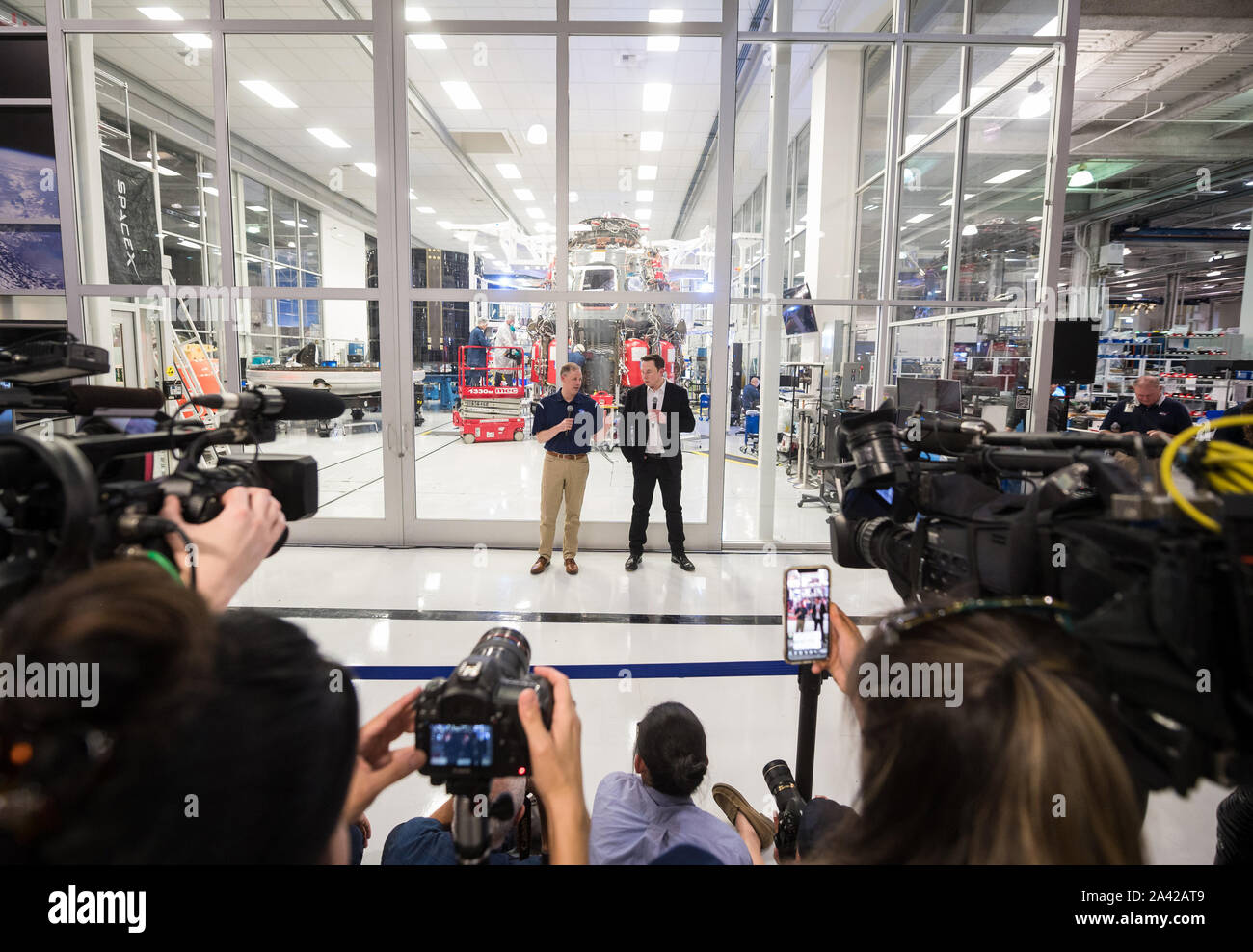Hawthorne, United States. 11th Oct, 2019. NASA Administrator Jim Bridenstine, left, and SpaceX Chief Engineer Elon Musk, right, speak to press in front of the Crew Dragon that is being prepared for the Demo-2 mission, at SpaceX Headquarters on October 10, 2019, in Hawthorne, CA. NASA Photo by Aubrey Gemignani/UPI Credit: UPI/Alamy Live News Stock Photo