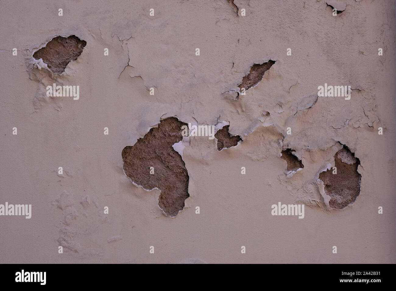 Old cracked and peeling plastered wall. Stock Photo