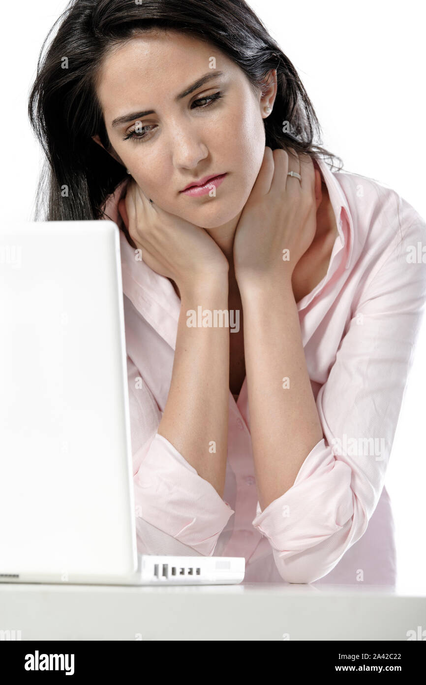 Beautiful young woman with neck pain at her office desk Stock Photo - Alamy