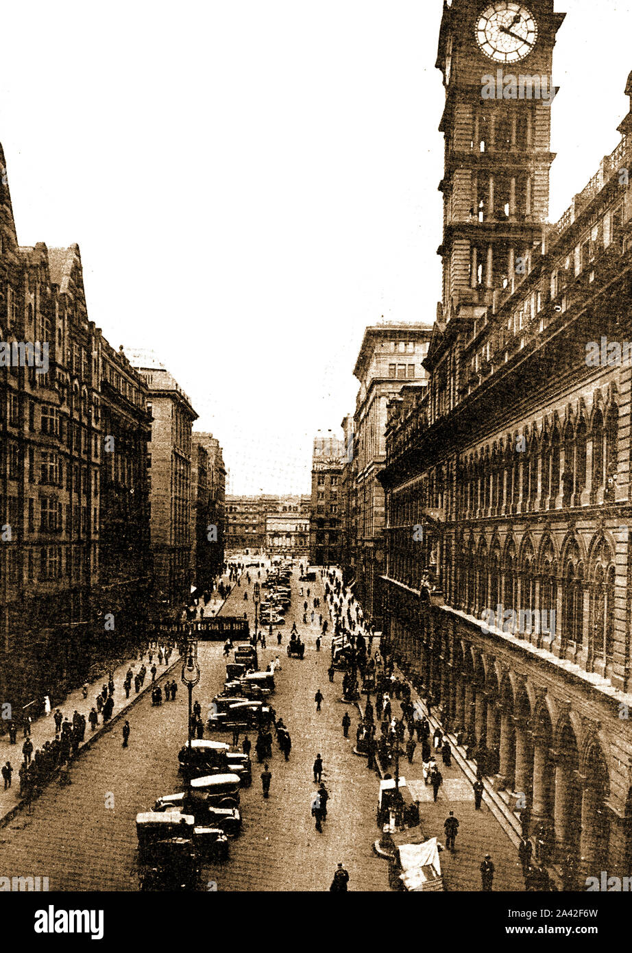 C1930's - An old photograph of Martin Place, Sydney,Australia showing a line of vintage motor vehicles parked down the centre of the street . Stock Photo