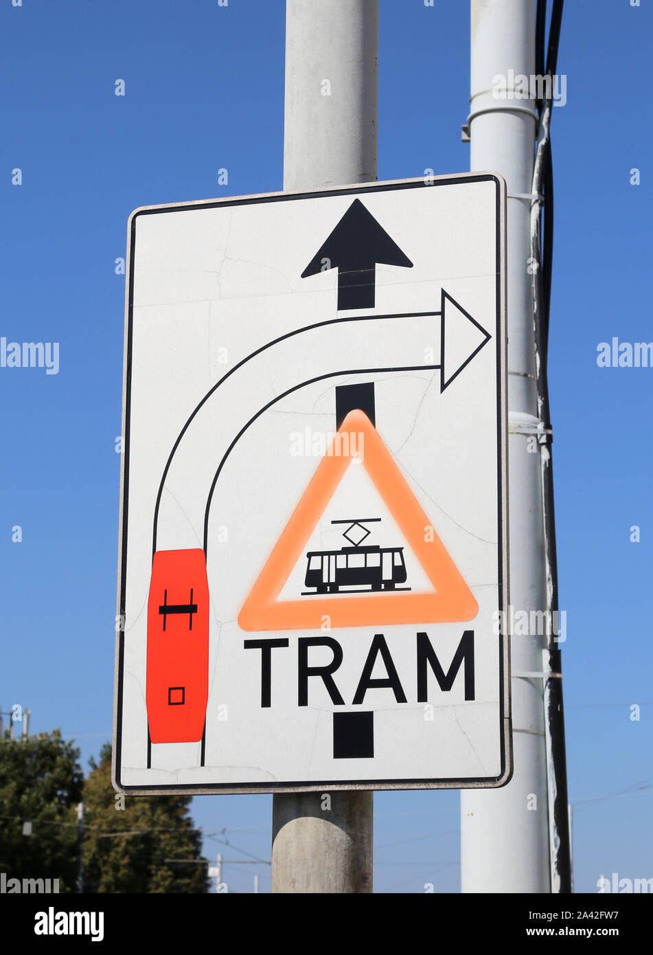 big road sign with attention signs of crossing tram tracks in the metropolitan city Stock Photo