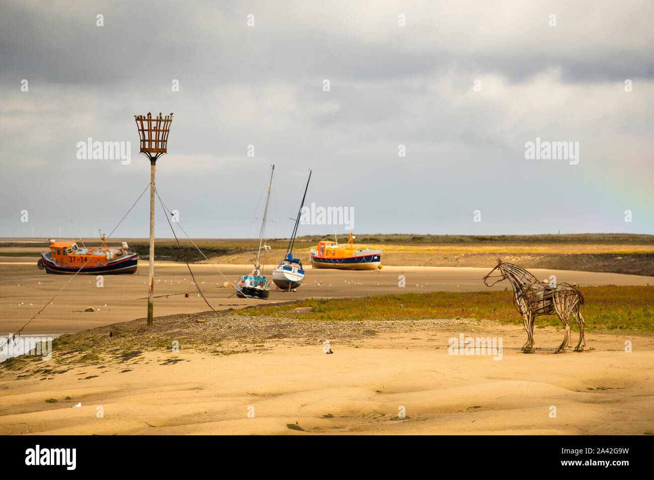 The lifeboat horse statue at WellsnexttheSea with two historic lifeboats in the background