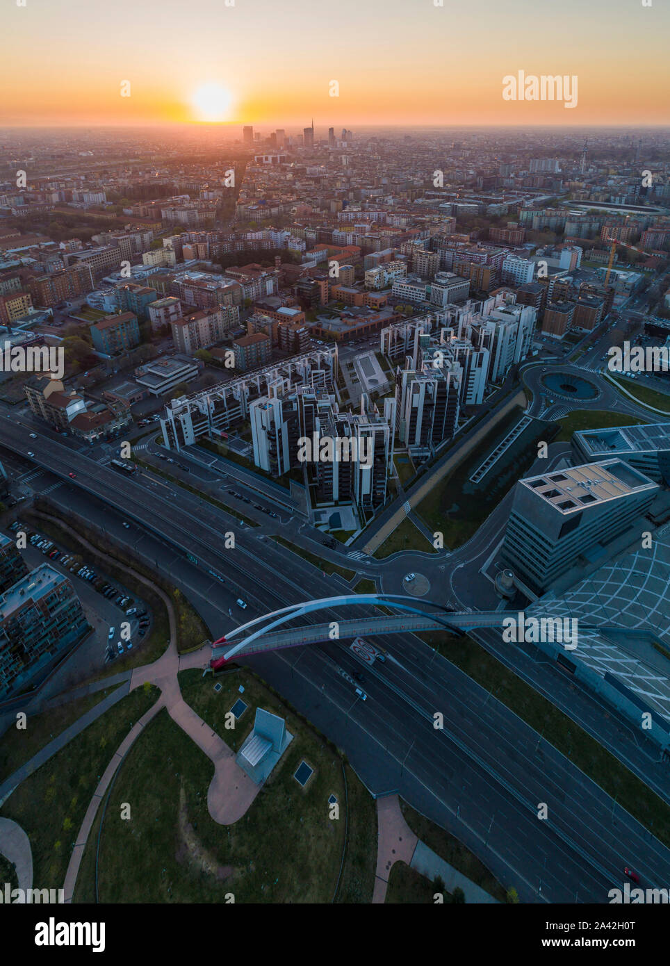 Aerial view of Milan skyline at dawn. Flying over building and boulevard. Stock Photo