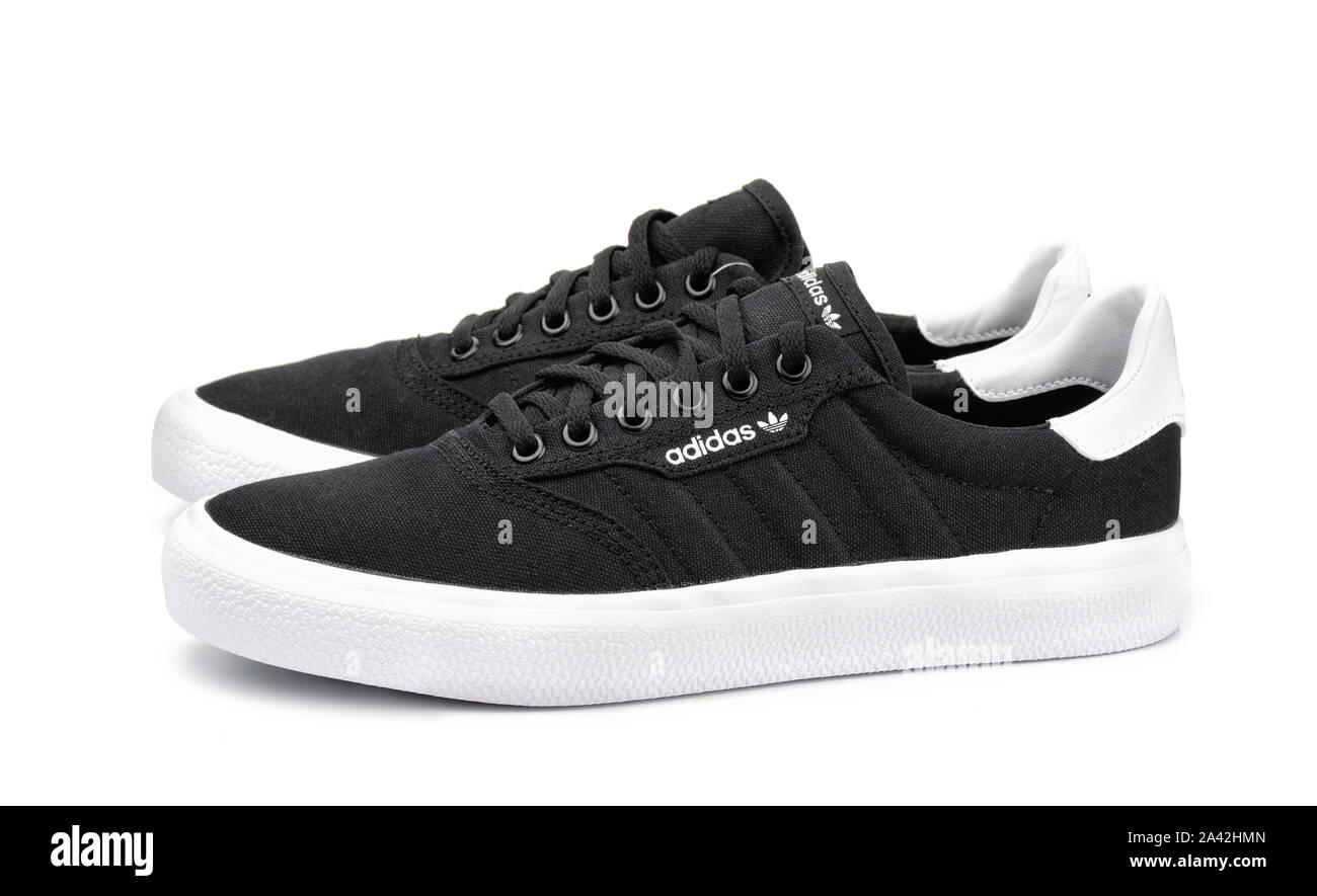 Samara, Russia - September 2018. Product shot of black canvas Adidas sneakers isolated on white Stock Photo