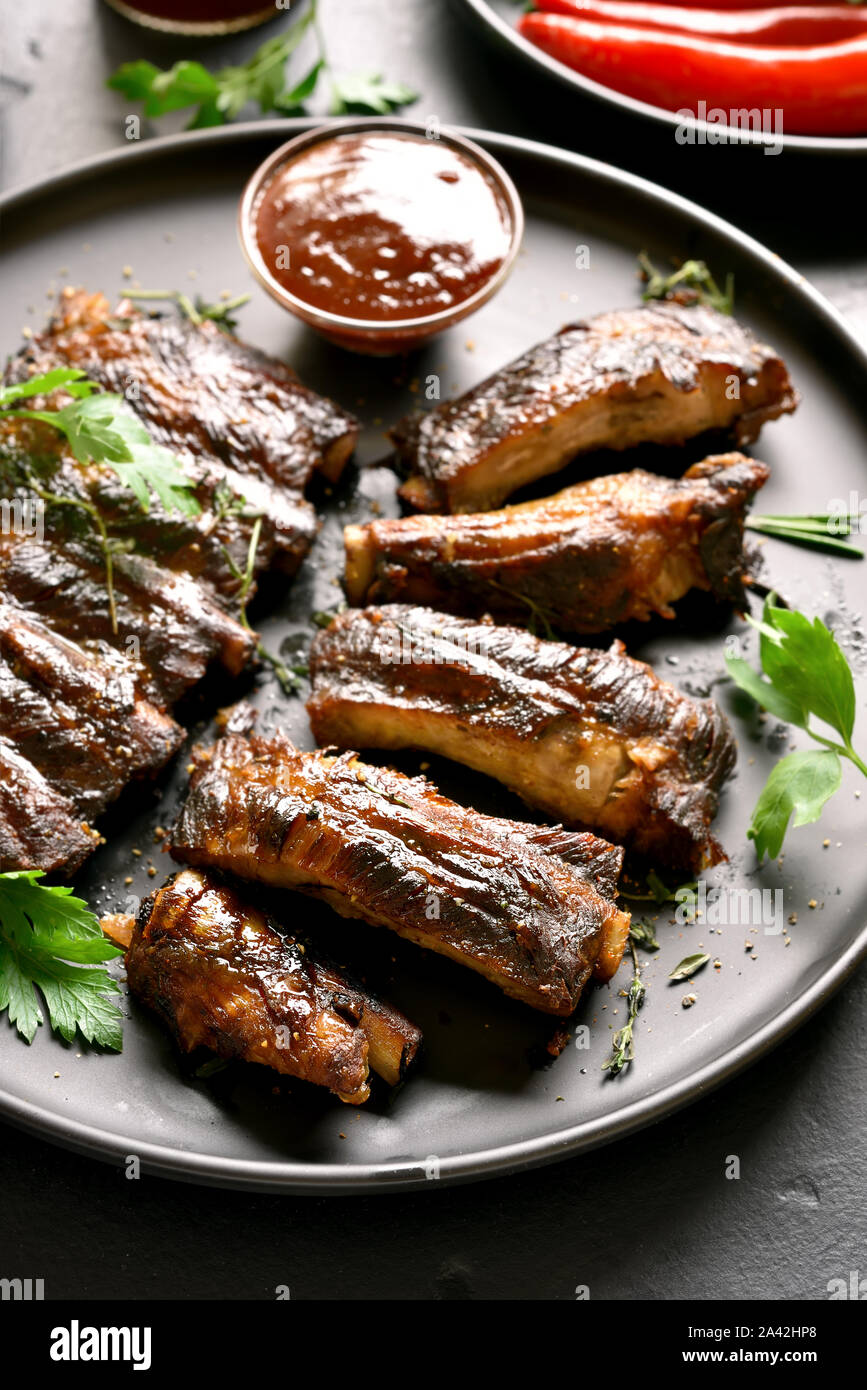 Barbecue spare ribs on plate. Tasty grilled meat. Stock Photo