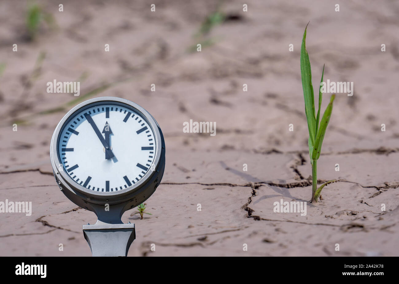 Climate change dryness with clock Stock Photo Alamy