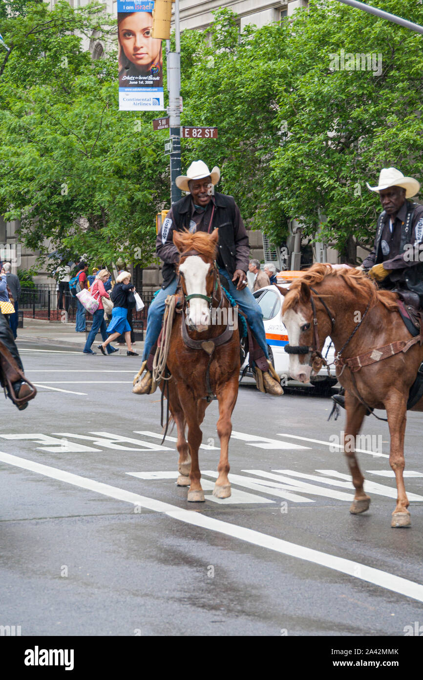 New York, USA. May 2008 Cowboys ride horses in 5th avenue near Central