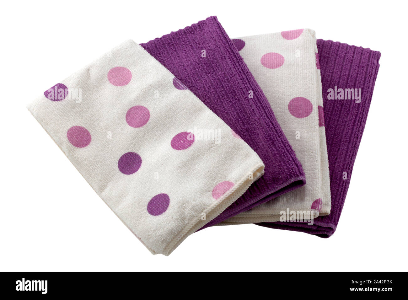 Set of microfiber dust cloths in purple and white with polka dots. Cloths are on a white background. Stock Photo