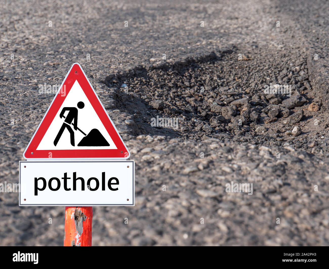 Large pothole Warning sign Stock Photo