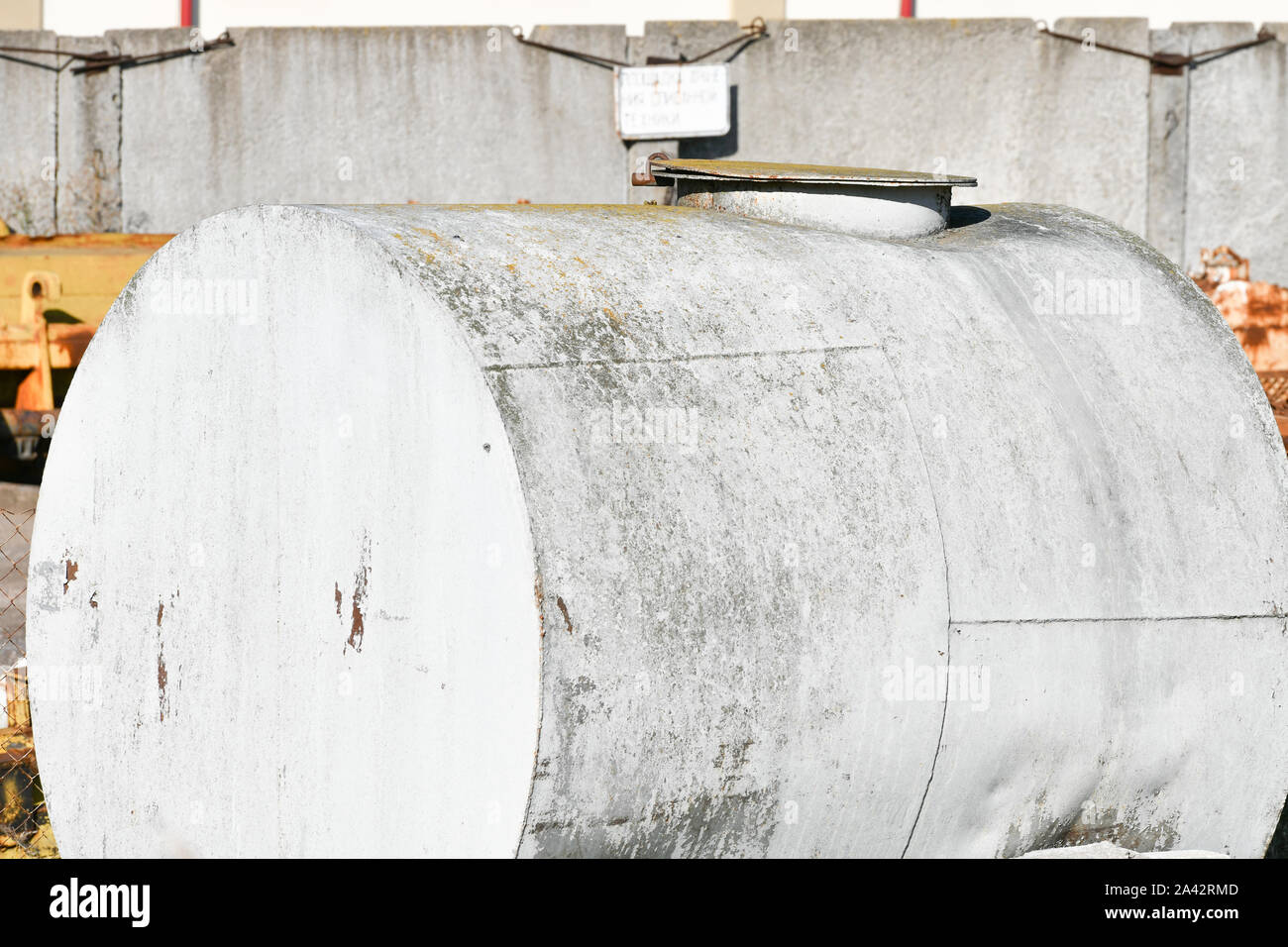 Old rusty fuel tanks in the yard. Clear sunny summer day abandoned old