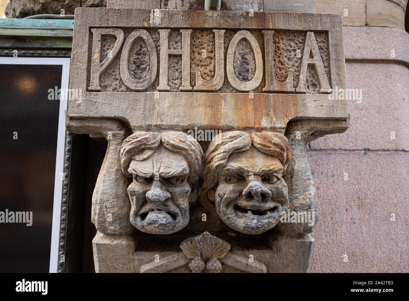 Carved scowling faces on a building in central Helsinki, Finland Stock Photo