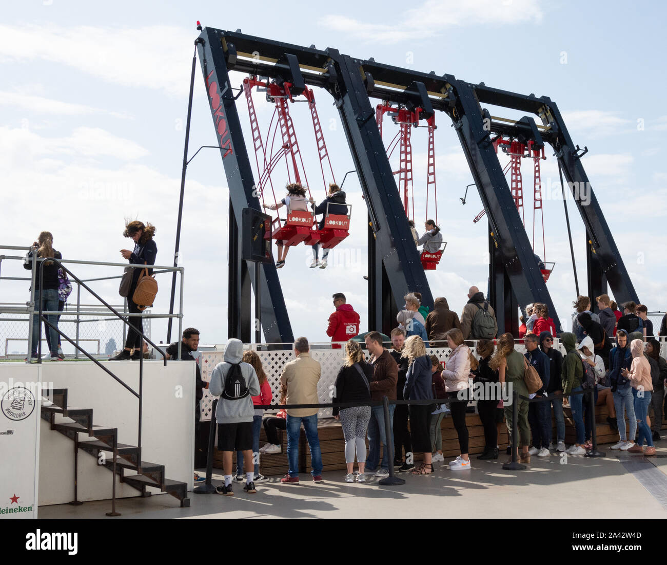 Tourists enjoy the "over the edge" swings on the A'DAM Lookout Tower in  Amsterdam Noord. Europe's highest swing is 100 meters above the ground  Stock Photo - Alamy
