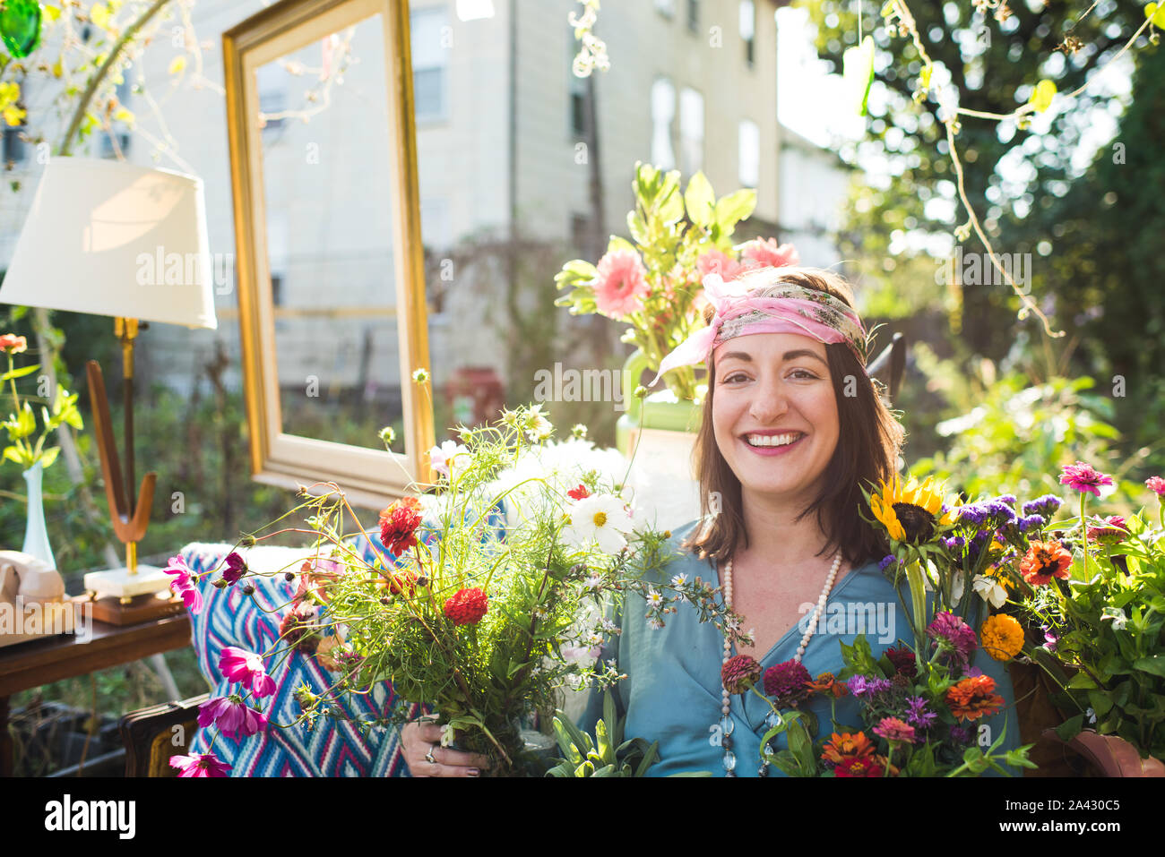 smiling woman in a garden with flowers Stock Photo