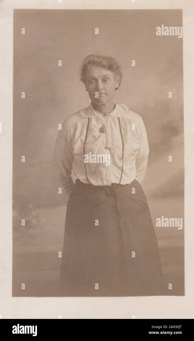 Vintage black and white photo postcard of a young woman (uniform?) 1900s. Stock Photo