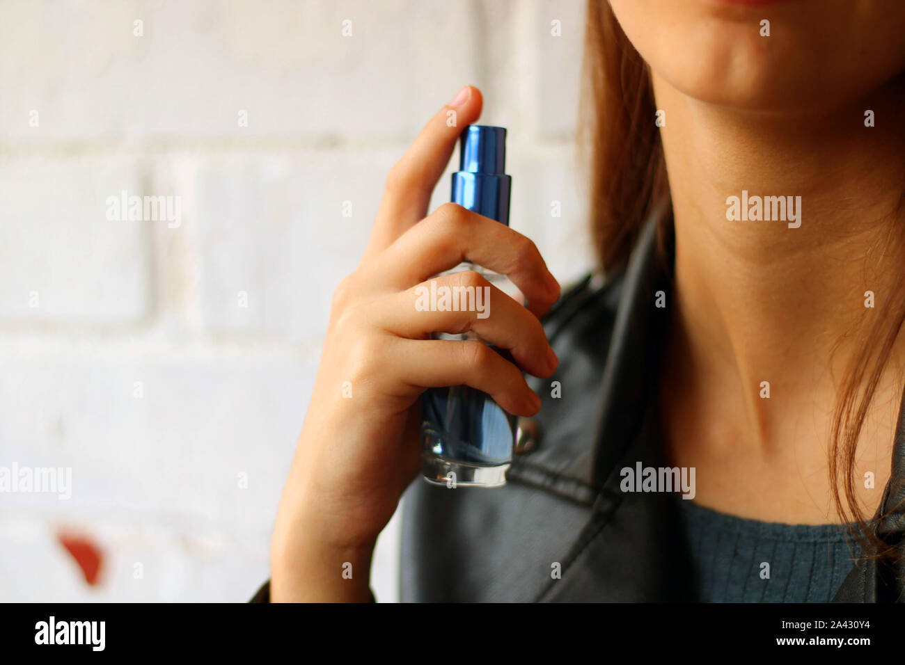 Download Beautiful Young Girl Dressed In Yellow Spraying Perfume From A Blue Bottle Stock Photo Alamy Yellowimages Mockups