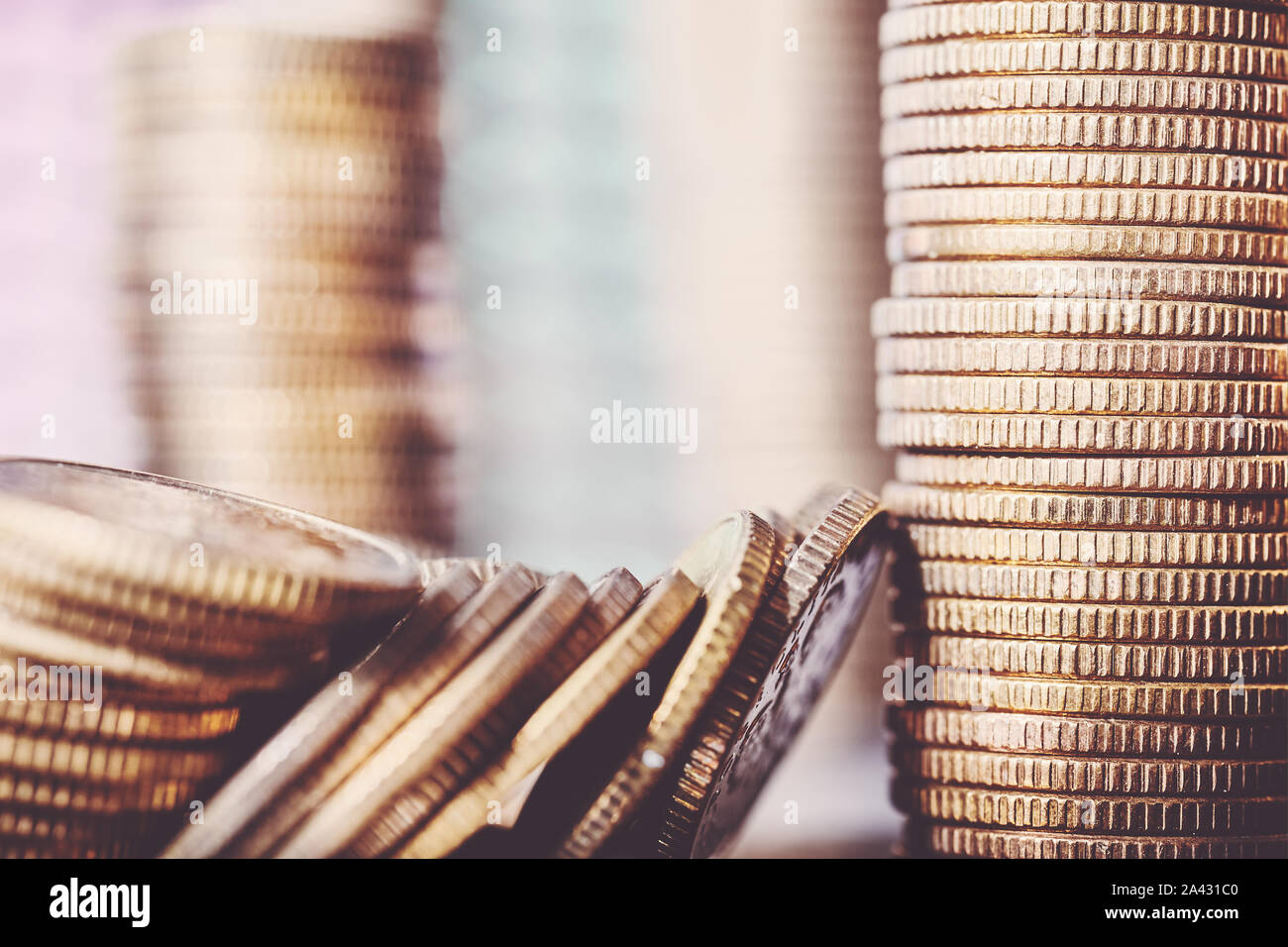Close up picture of golden coins, shallow depth of field, color toning applied. Stock Photo