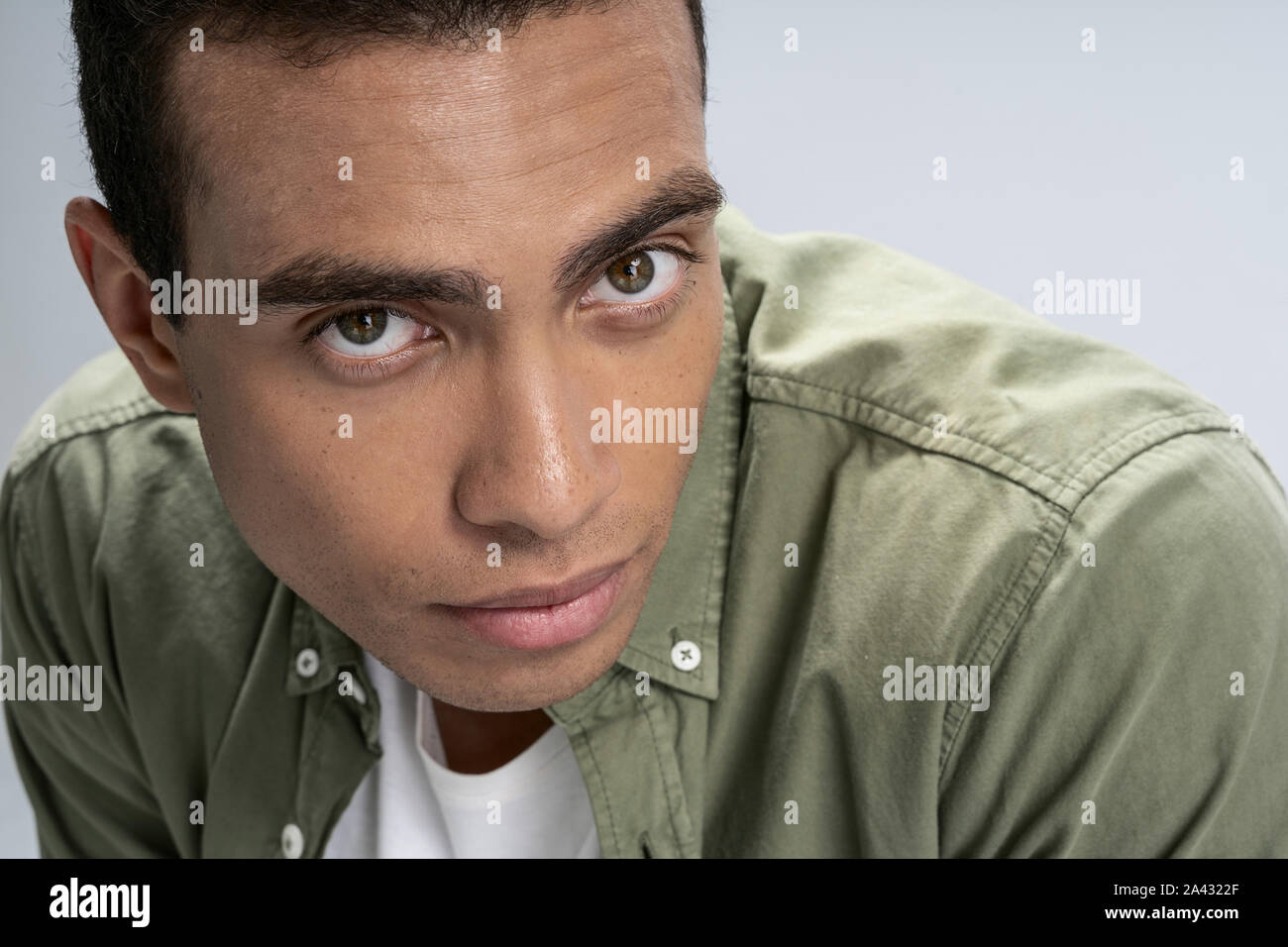 Handsome young man being serious and deep in thought Stock Photo